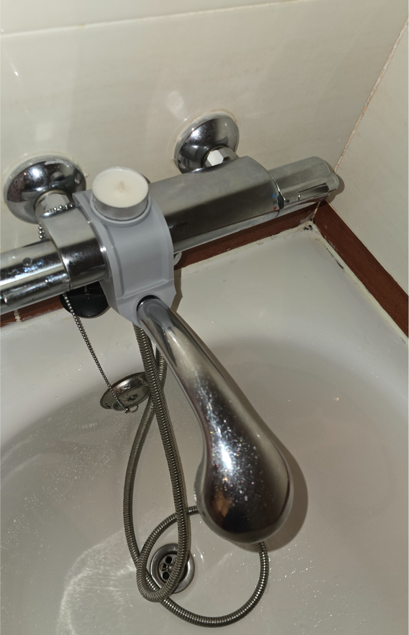 Shower head bracket and tea candle holder