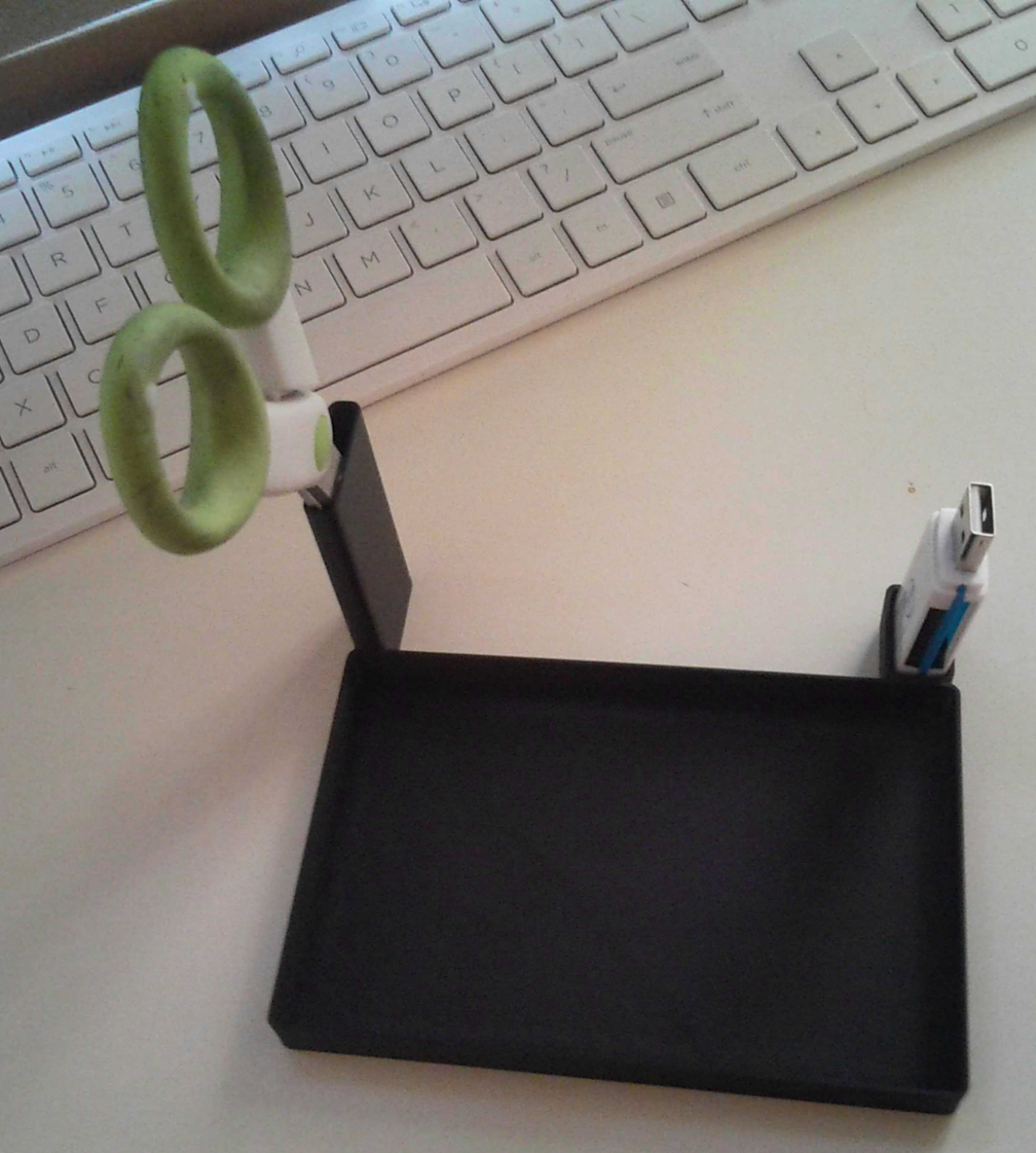 Desk organizer for USB, scissors, and camera.