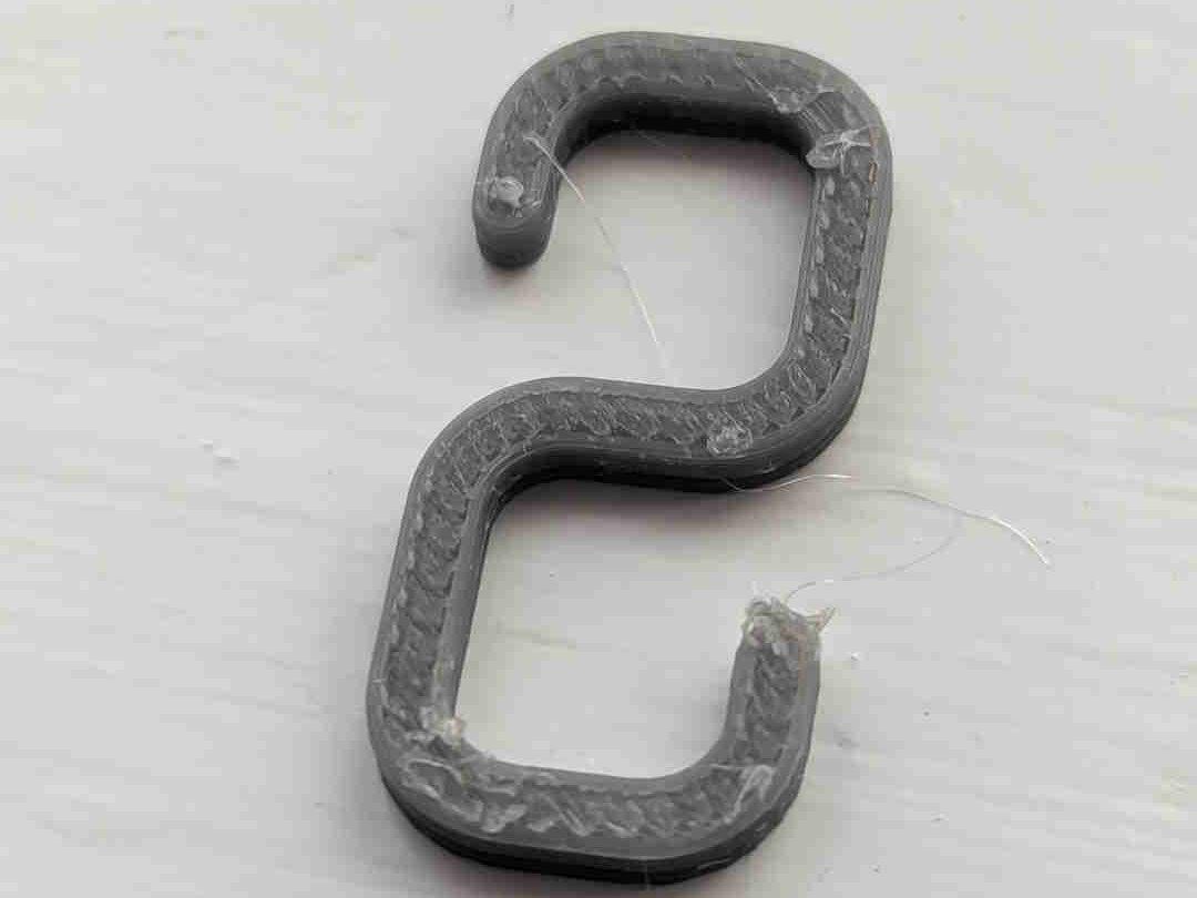Small hook for hanging lights on net curtain rail