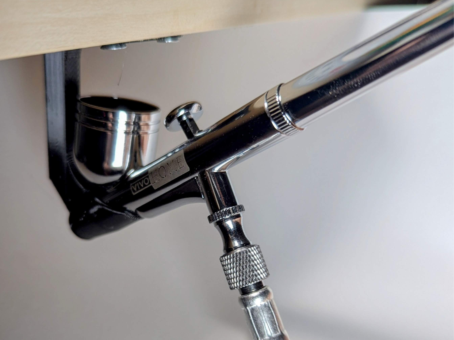 Under shelf airbrush holder