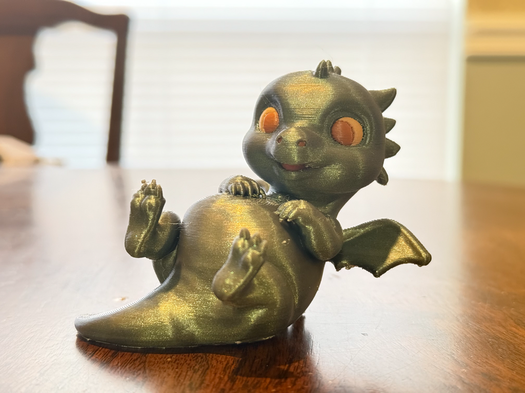 Adorable lounging baby dragon