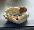 Cupped hands with birds on wrist holder