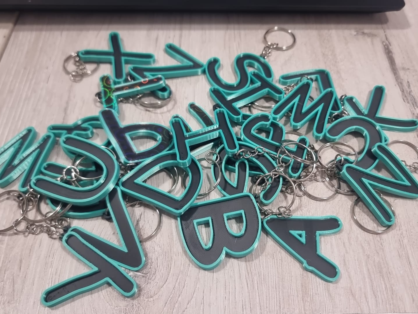 Letters for keychains with raised edge