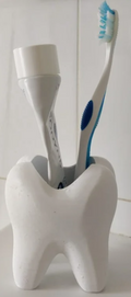 Toothlike holder/cup for bathroom utilities