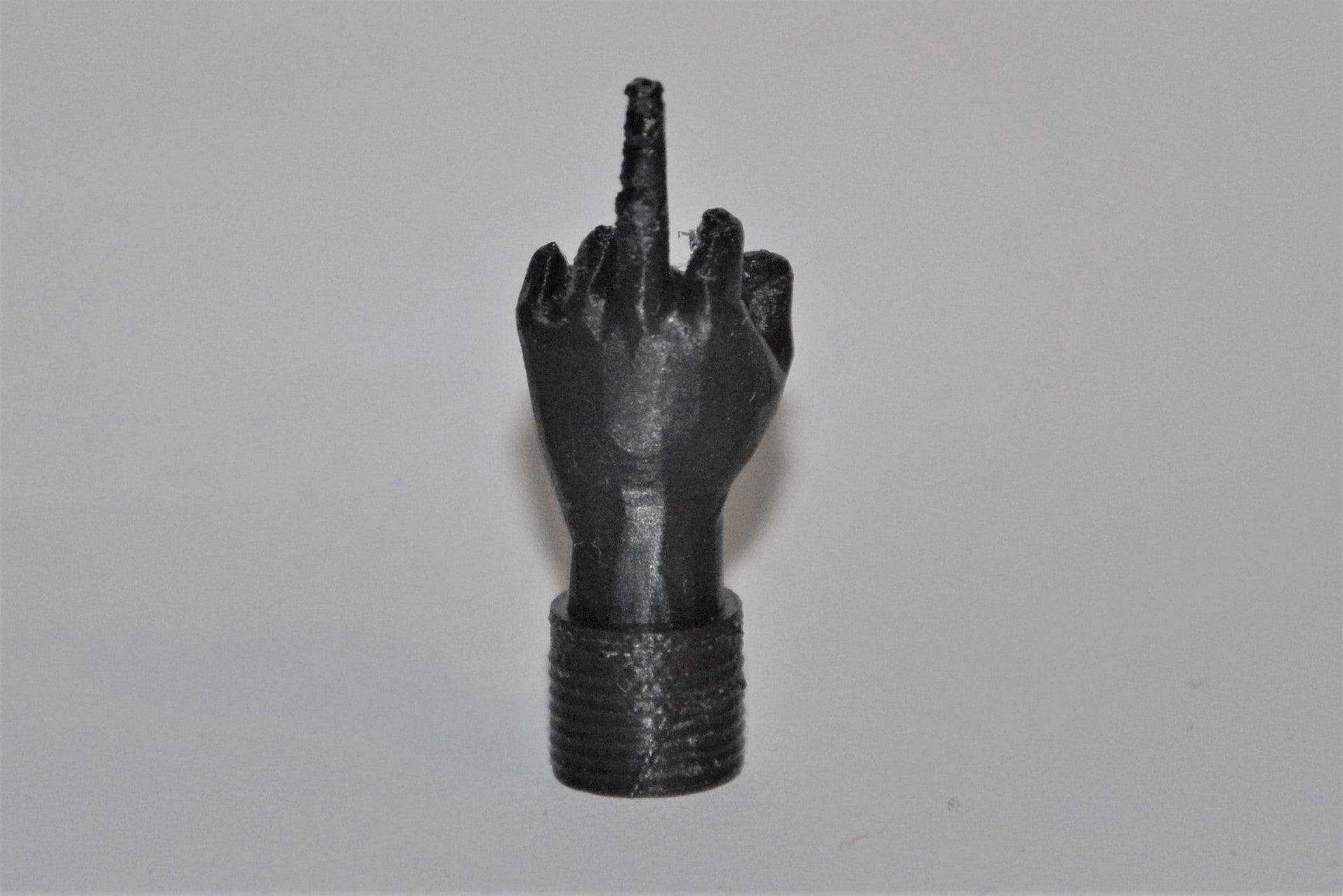 Middle finger schrader valve cap