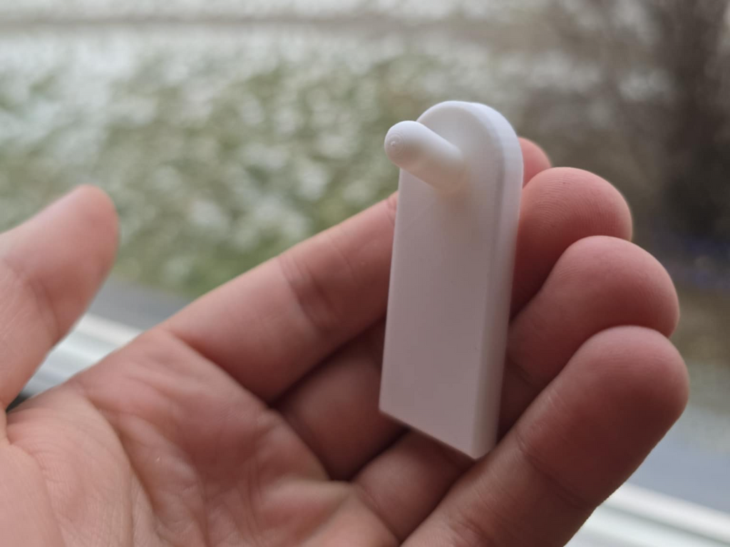 Flush wall hook using adhesive