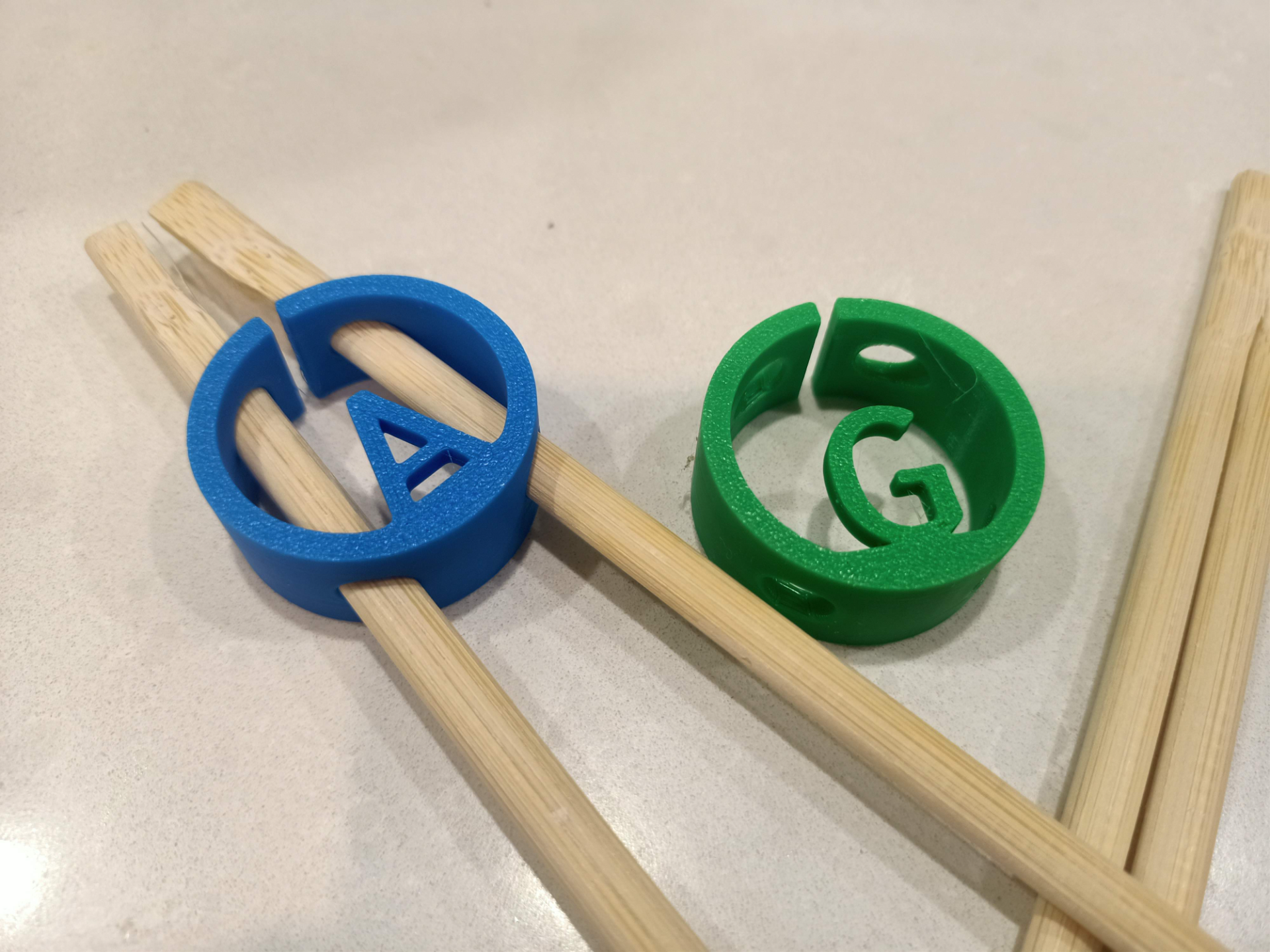 Chopstick gripper / holder with optional letter