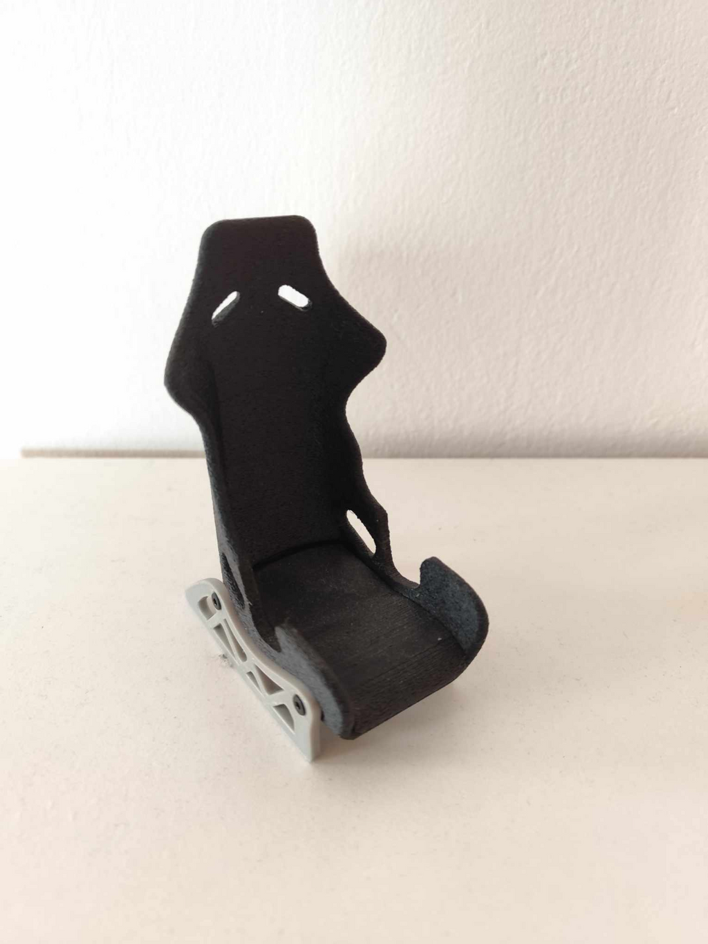 Racing seat phone stand