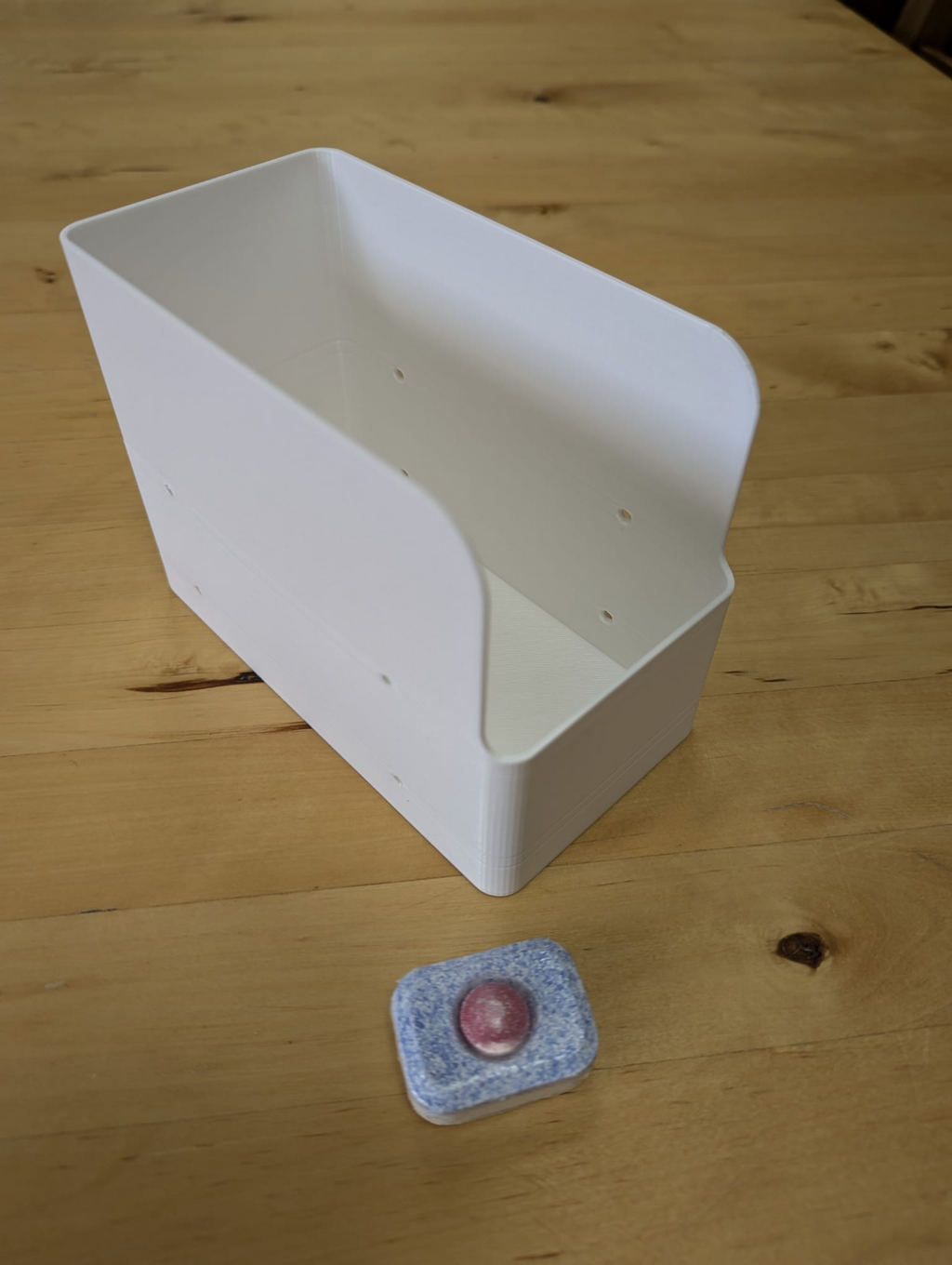 Dishwasher tab holder with screw holes