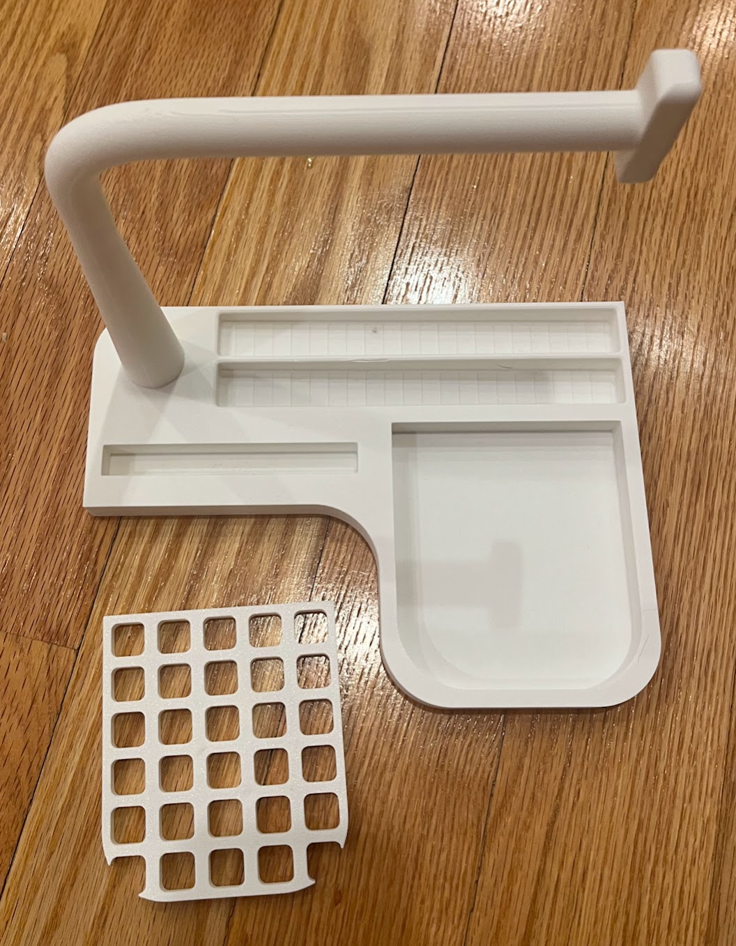 Desk caddy. Watch bar; slots: cup, phone, and pens