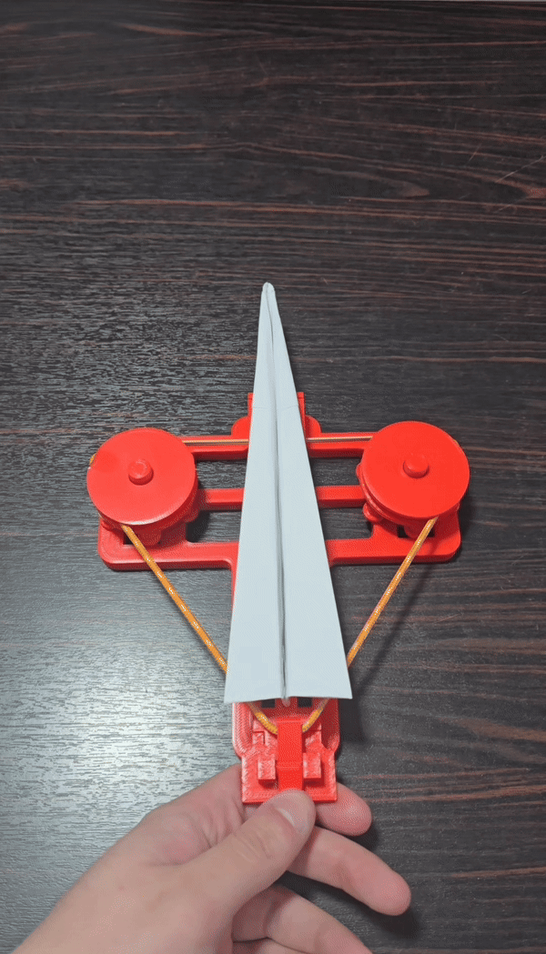 Rubber band paper plane launcher