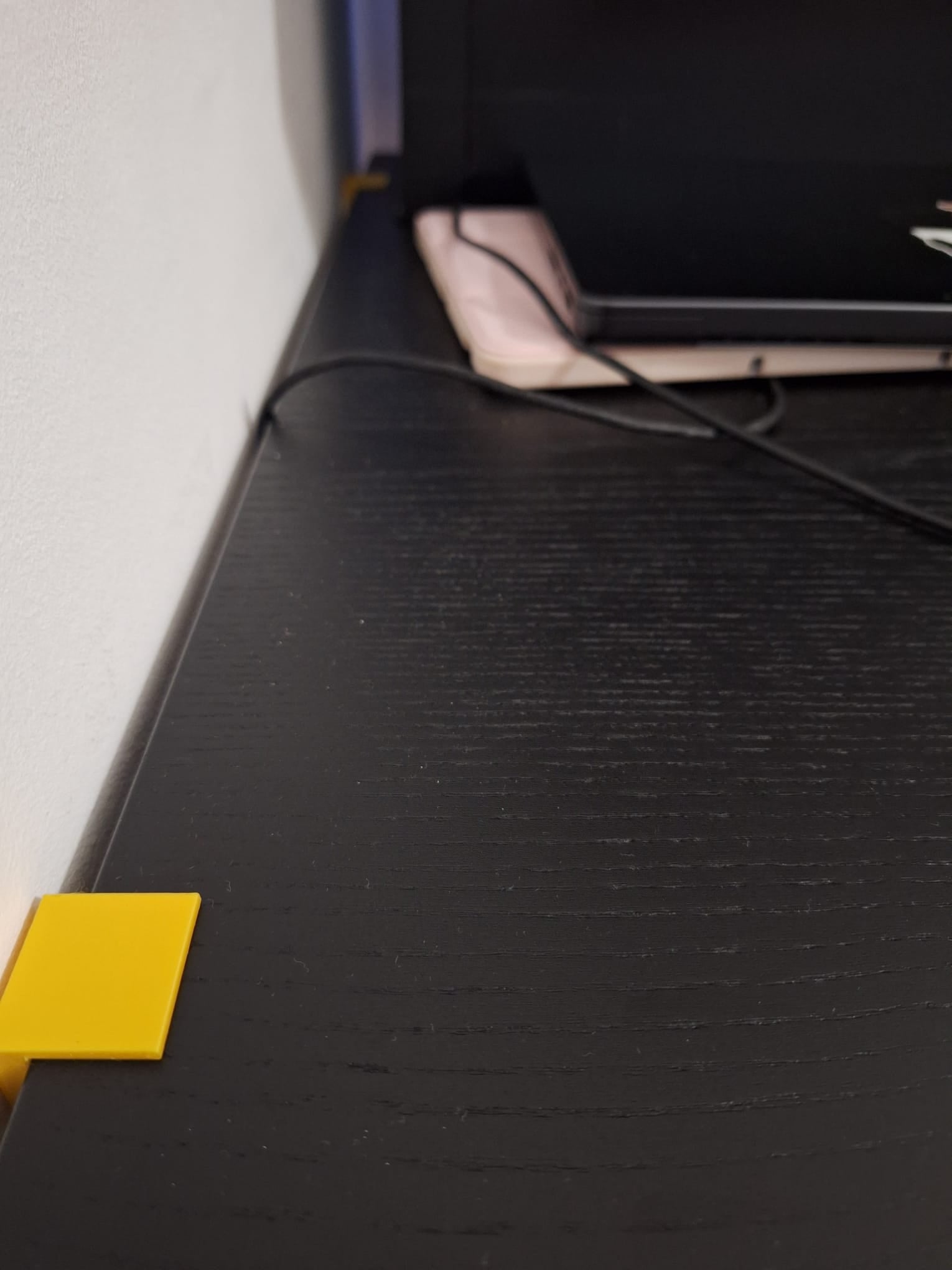 Desk wall spacer