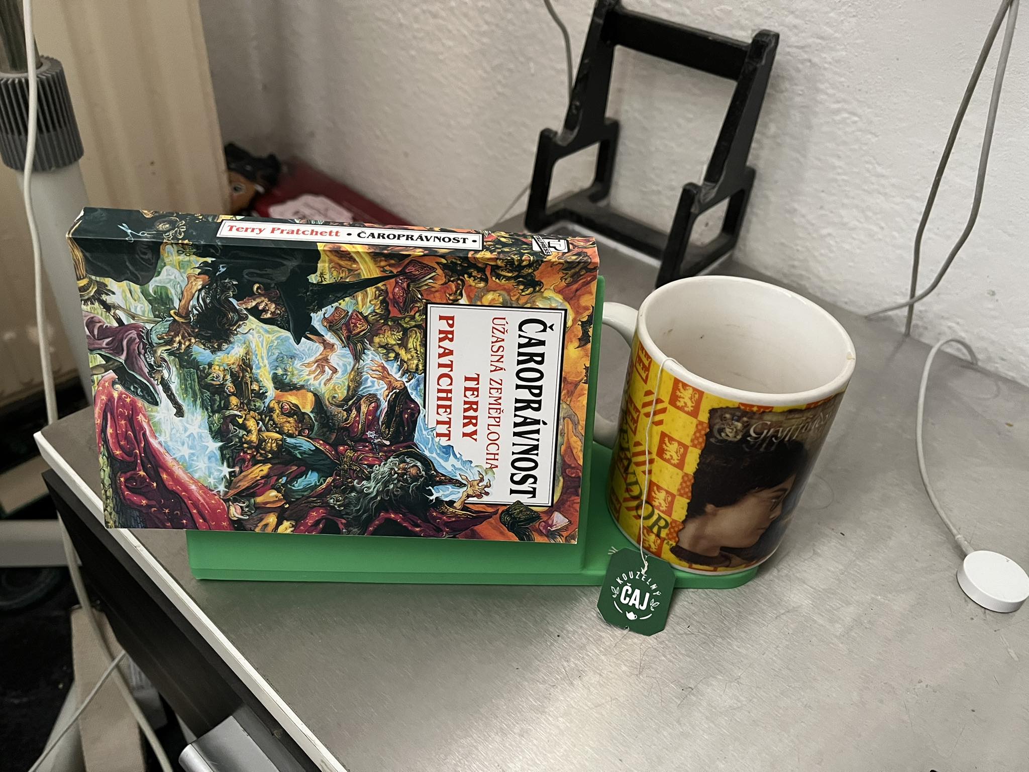 Holder for a read book and a mug of tea