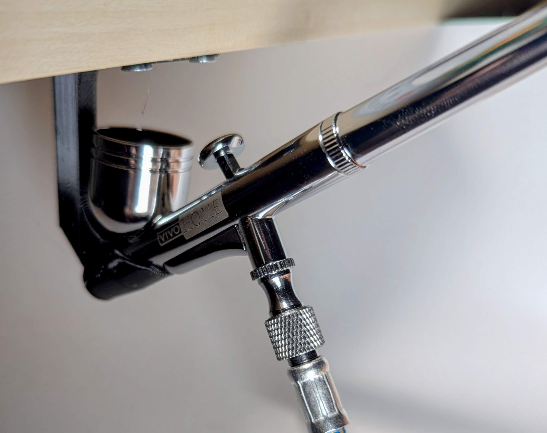 Under shelf airbrush holder