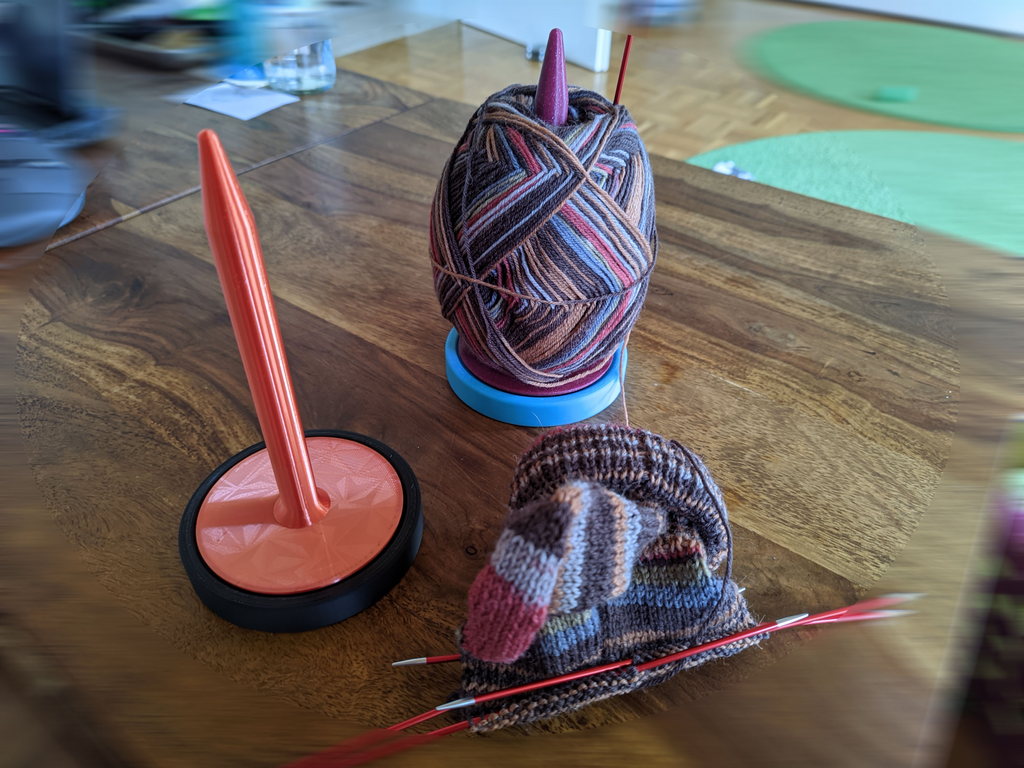 Yarn ball holder with ball bearing knitting gadget
