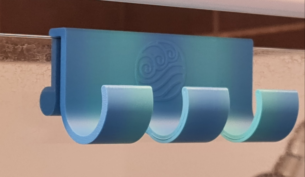 Shower hook with water tribe logo