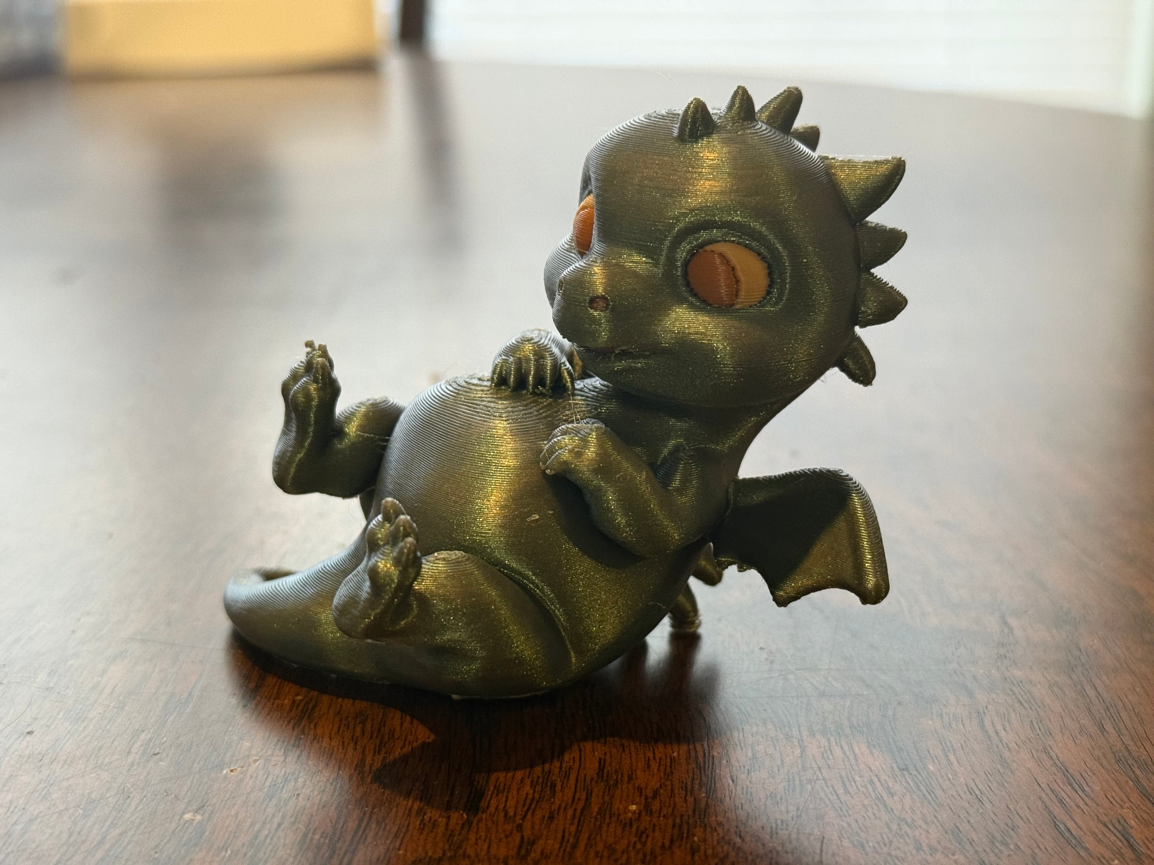 Adorable lounging baby dragon