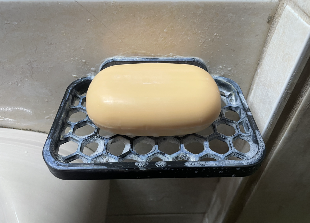 Soap holder with wall mounting hole