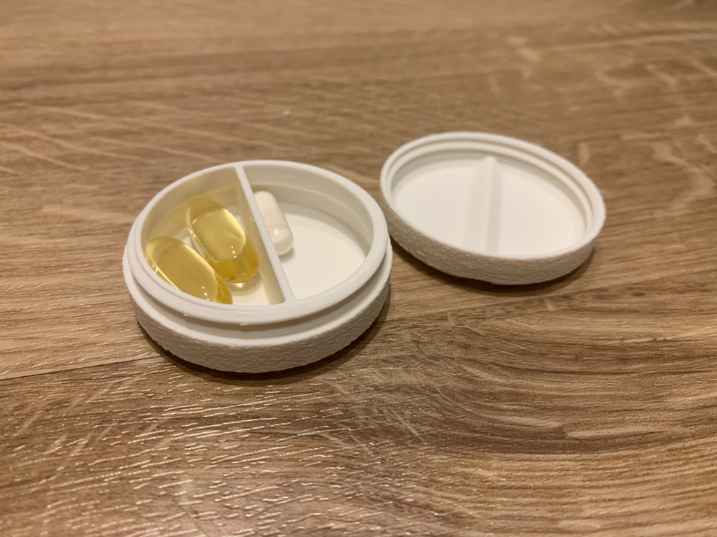 small pill-shaped two-segment pill organizer