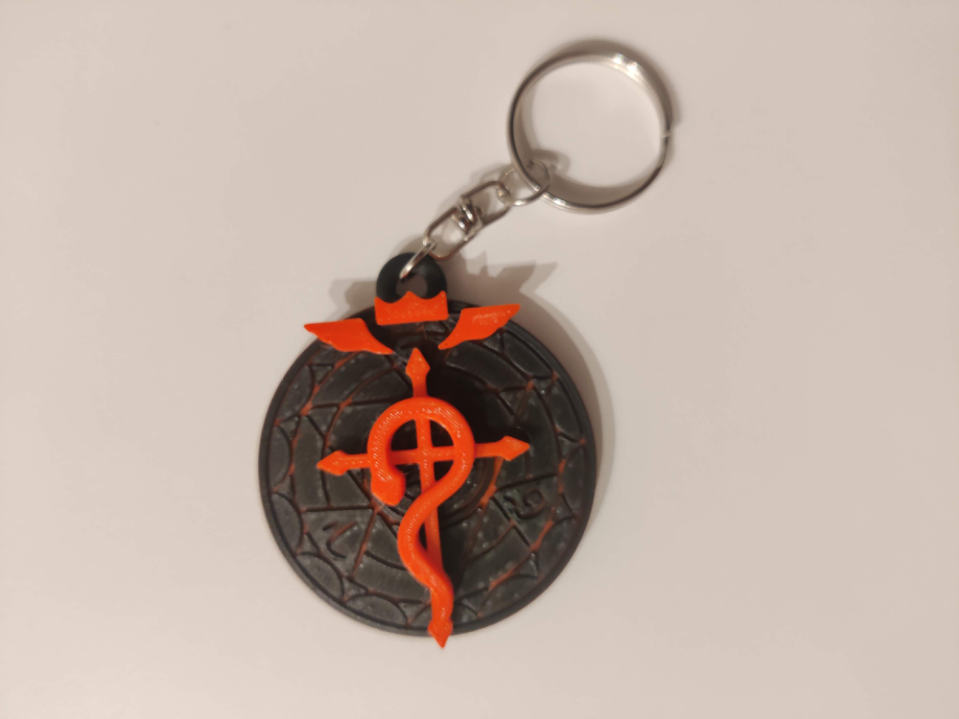 Fullmetal Alchemist logo colored keychain
