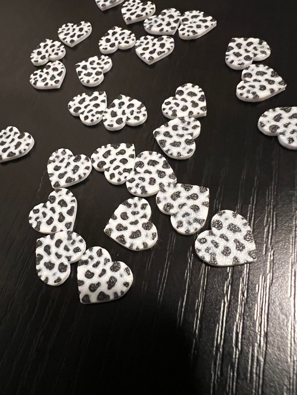 Cow print heart stud earrings