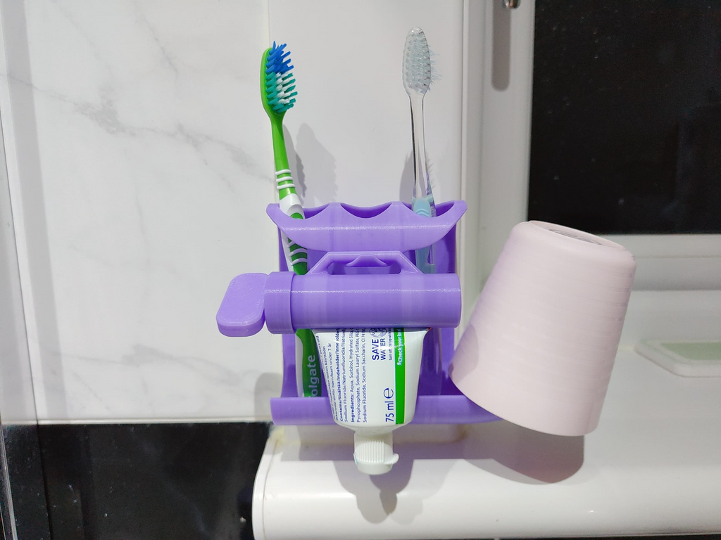 Toothpaste squeezer and toothbrush holder