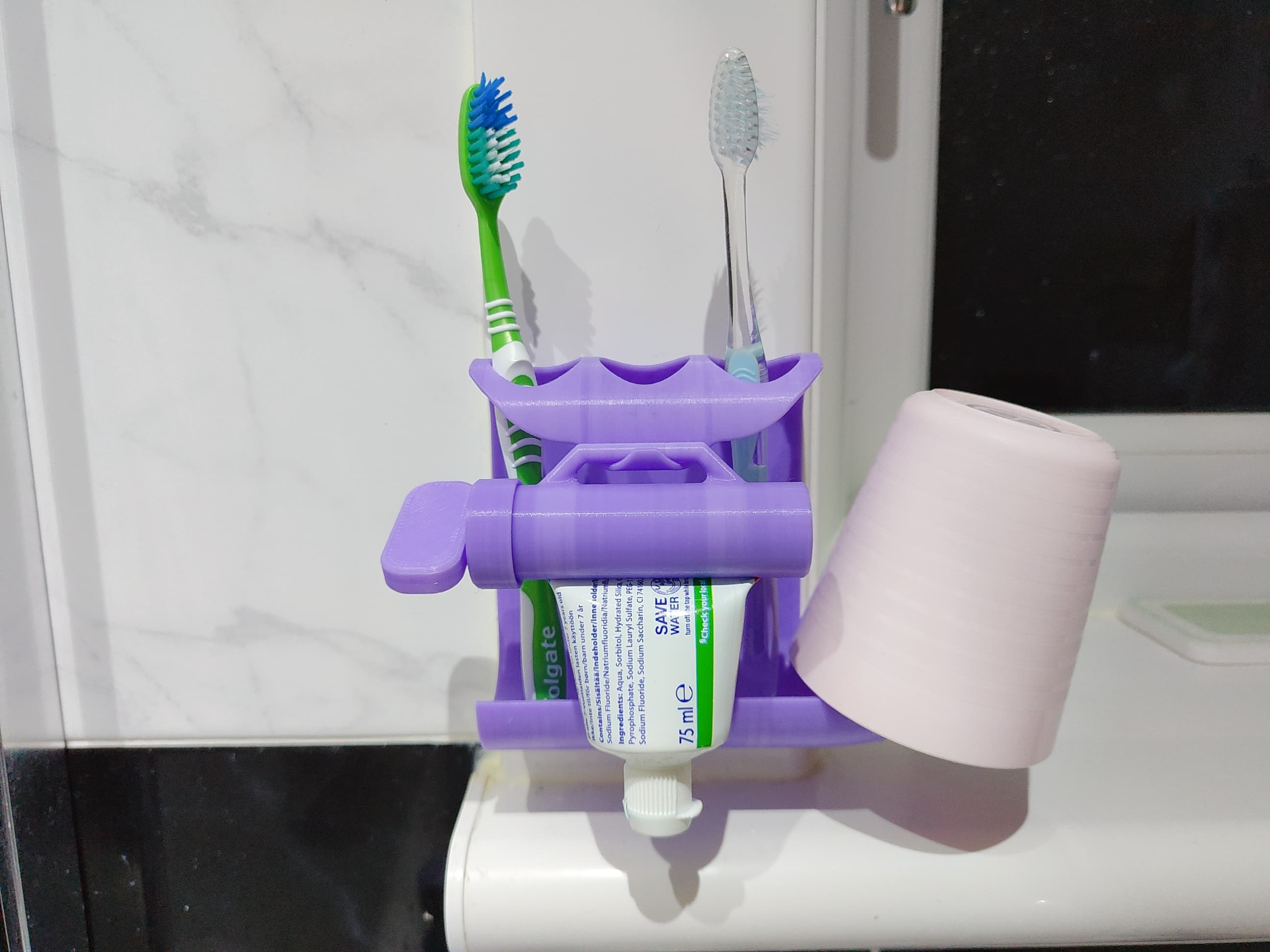 Toothpaste squeezer and toothbrush holder