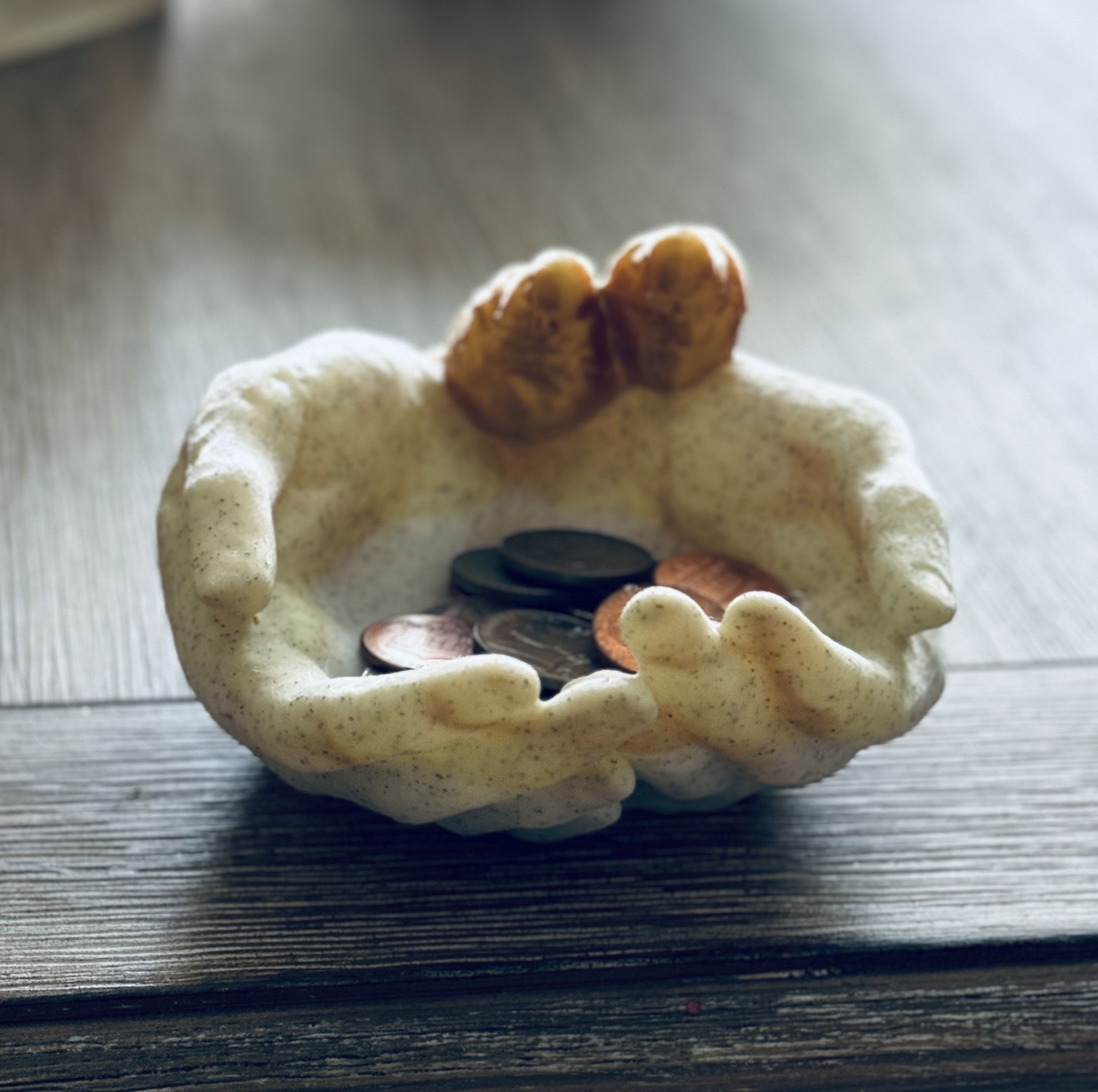 Cupped hands with birds on wrist holder