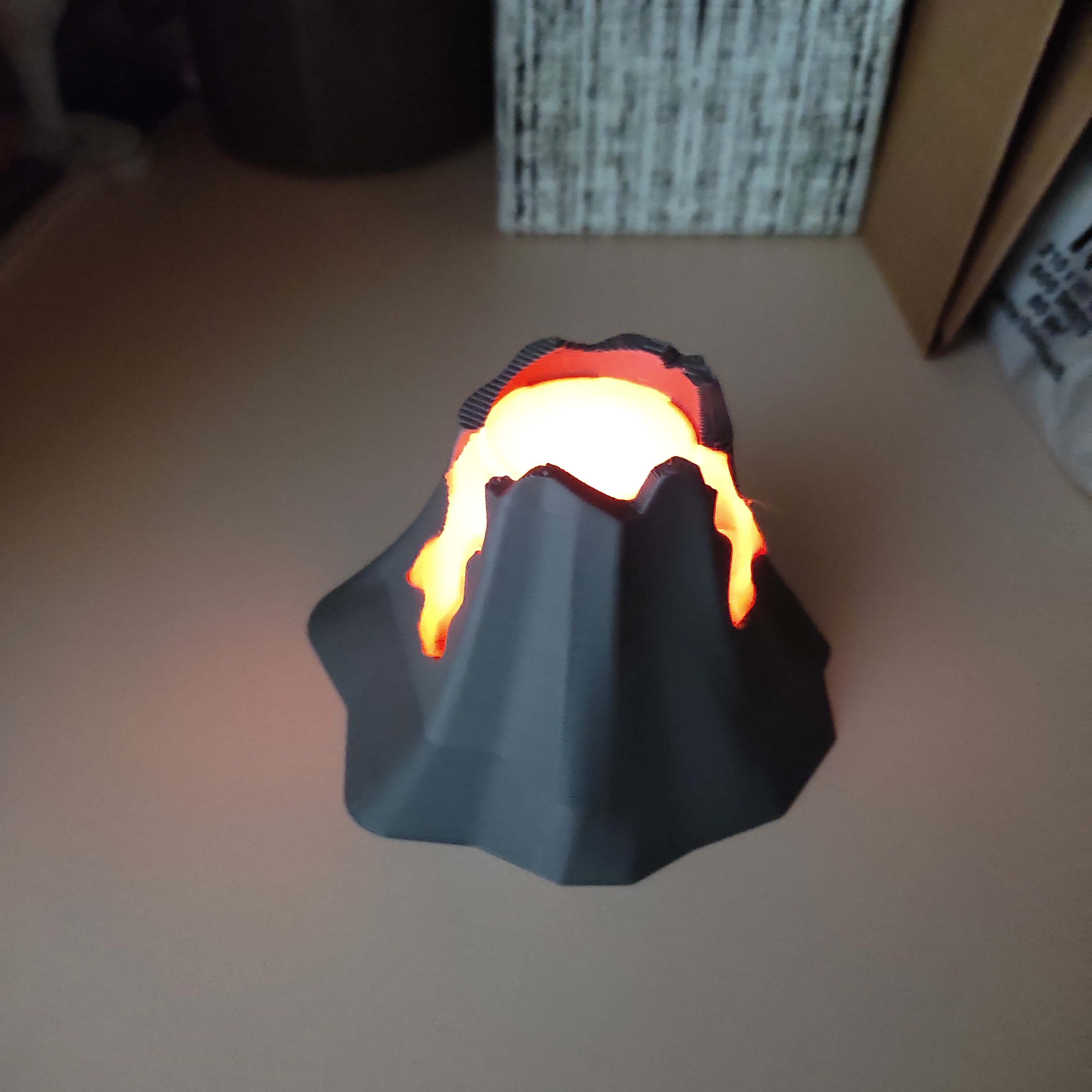 Erupting volcano diorama with glowing lava