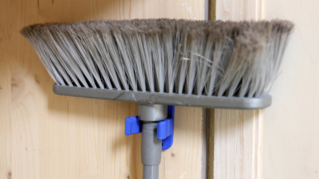 Universal hook for brooms and vacuum cleaners