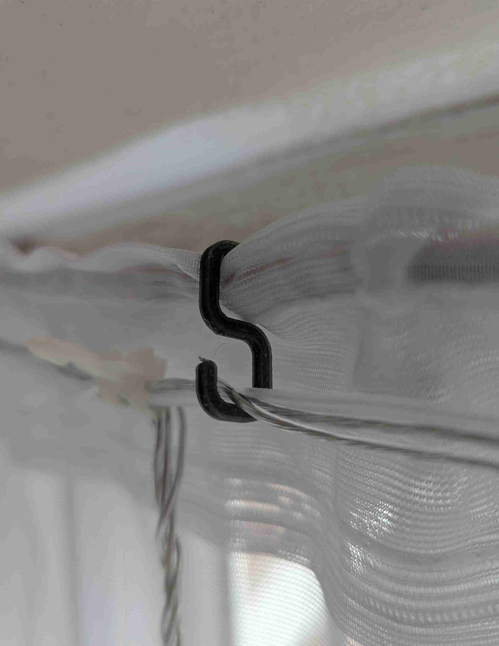 Small hook for hanging lights on net curtain rail