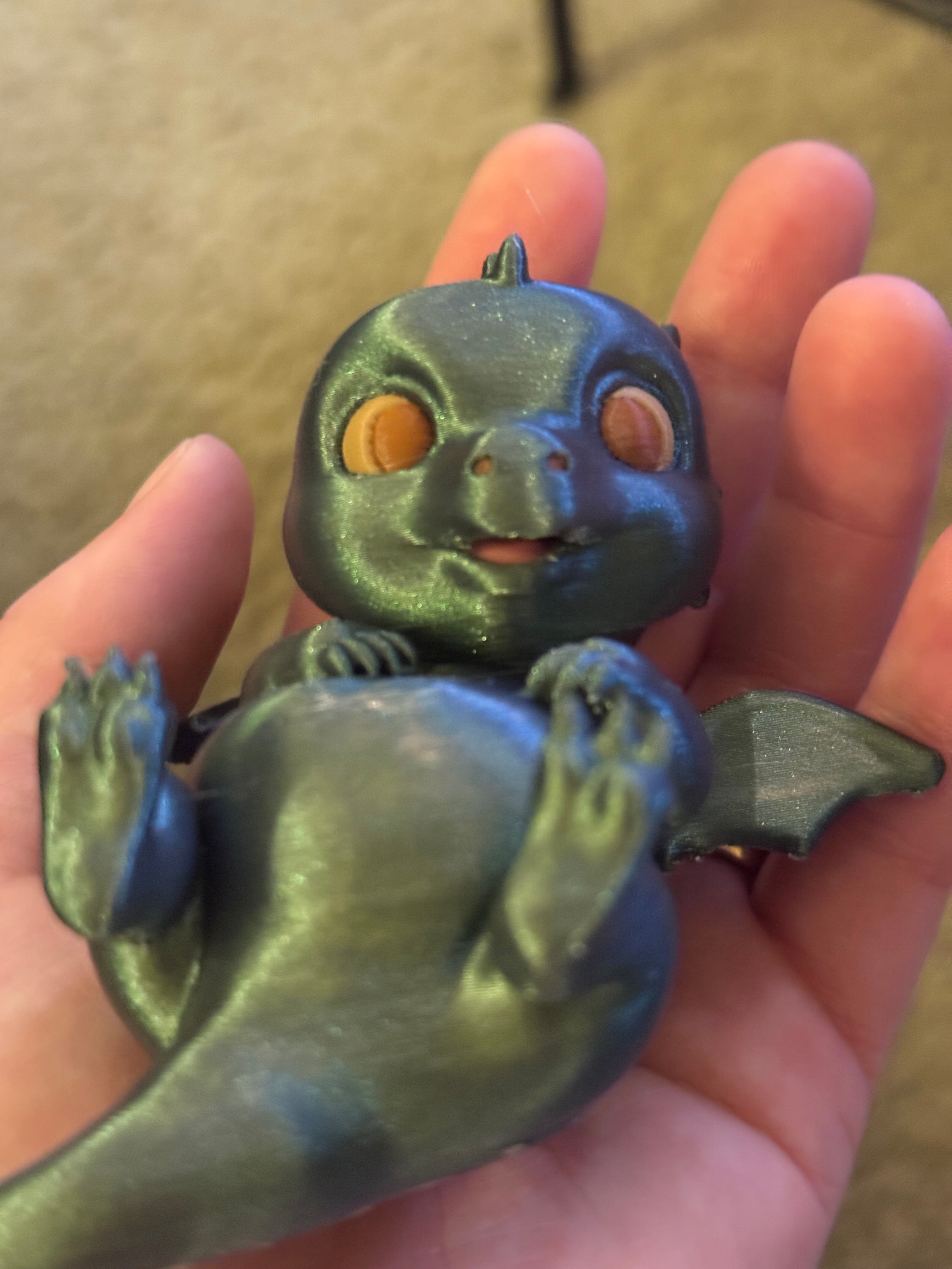 Adorable lounging baby dragon