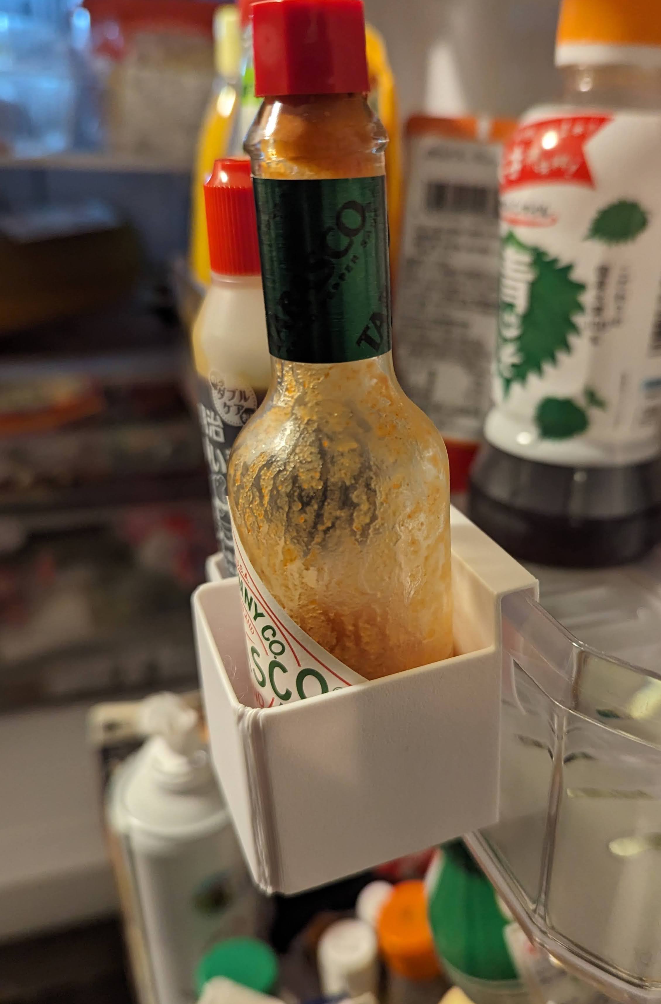 Fridge door hanging organizer for small bottles and pastes
