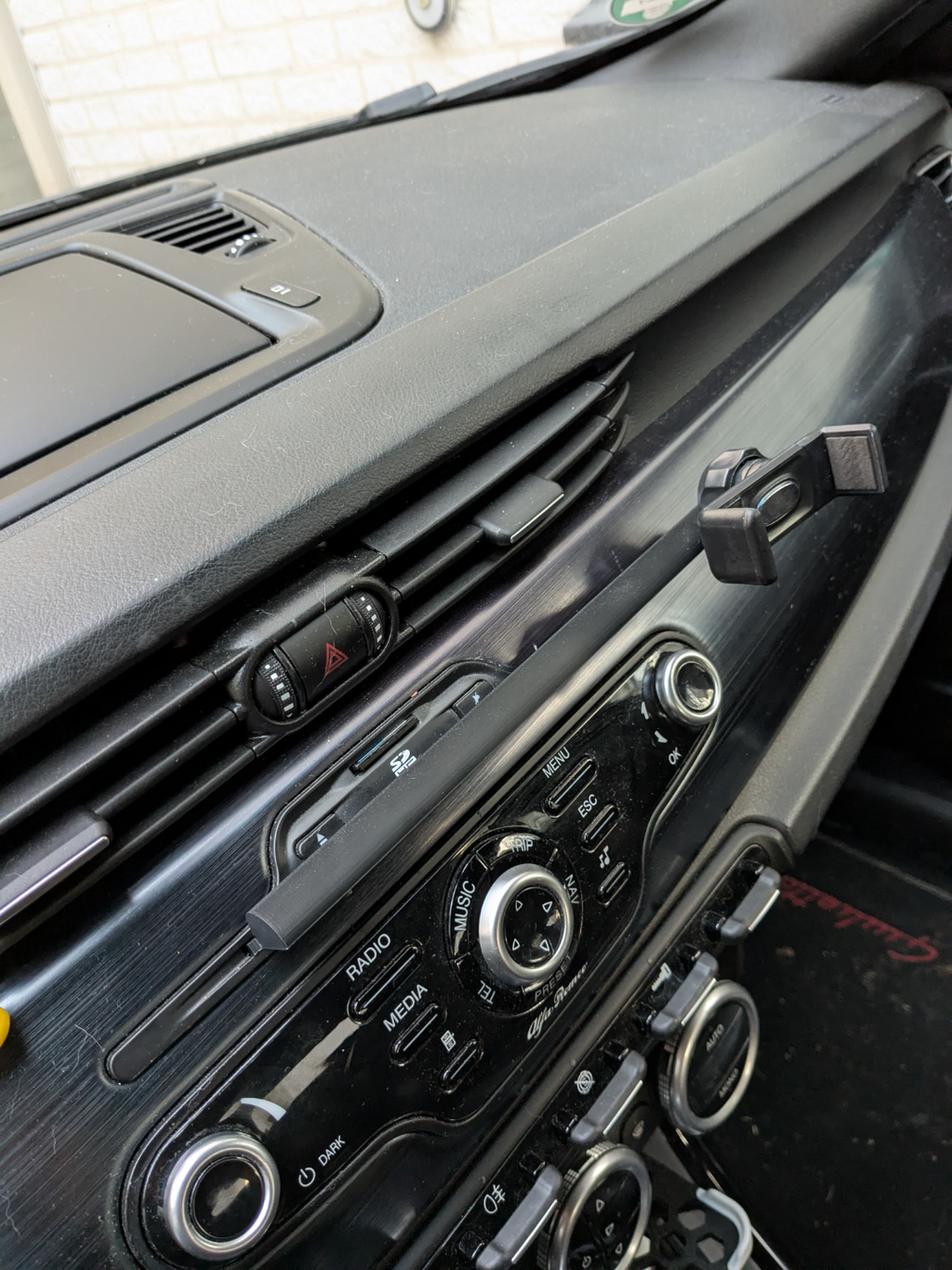 Car CD insert with extended arm for phone holders