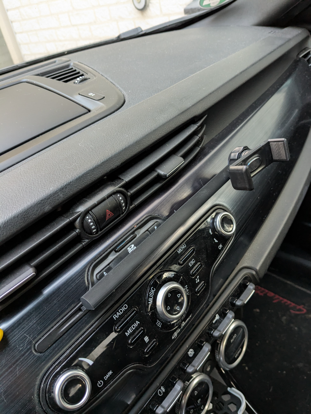 Car CD insert with extended arm for phone holders