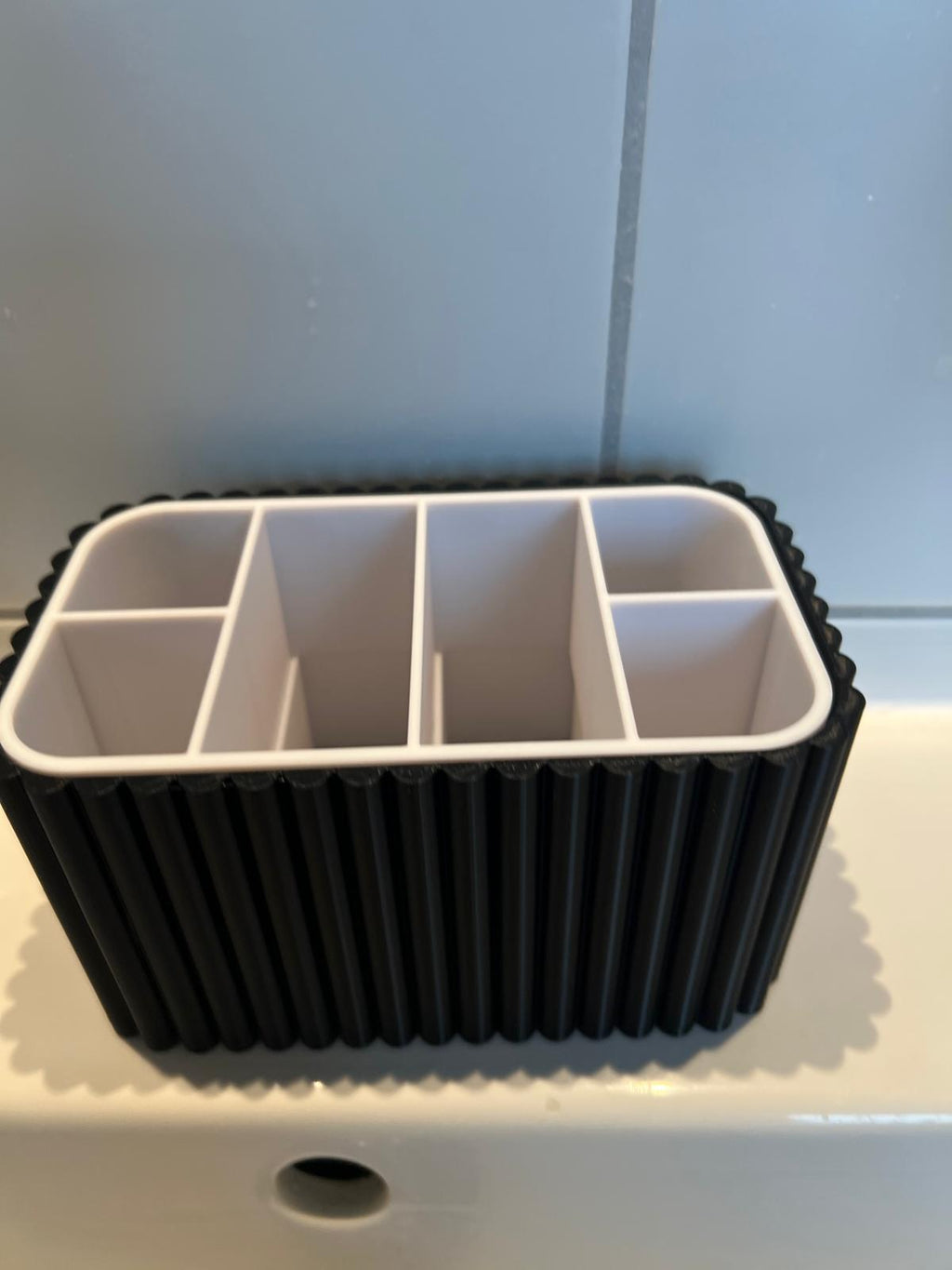 Bathroom toothbrush and toothpaste organiser