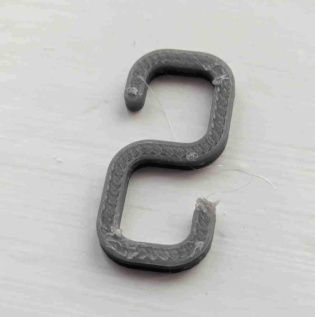 Small hook for hanging lights on net curtain rail