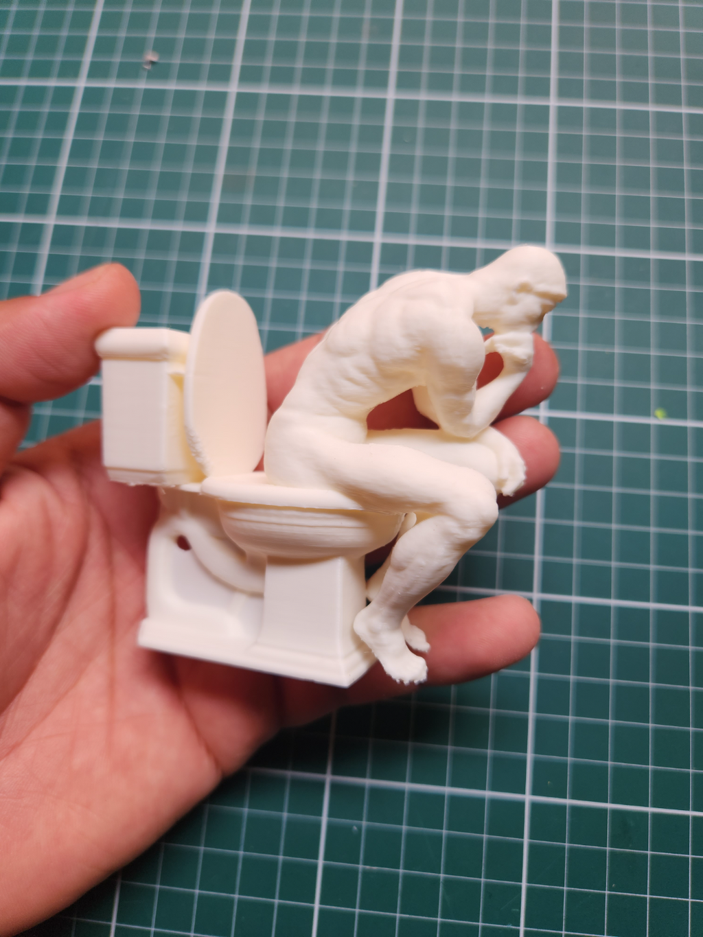 the Thinker on the toilet