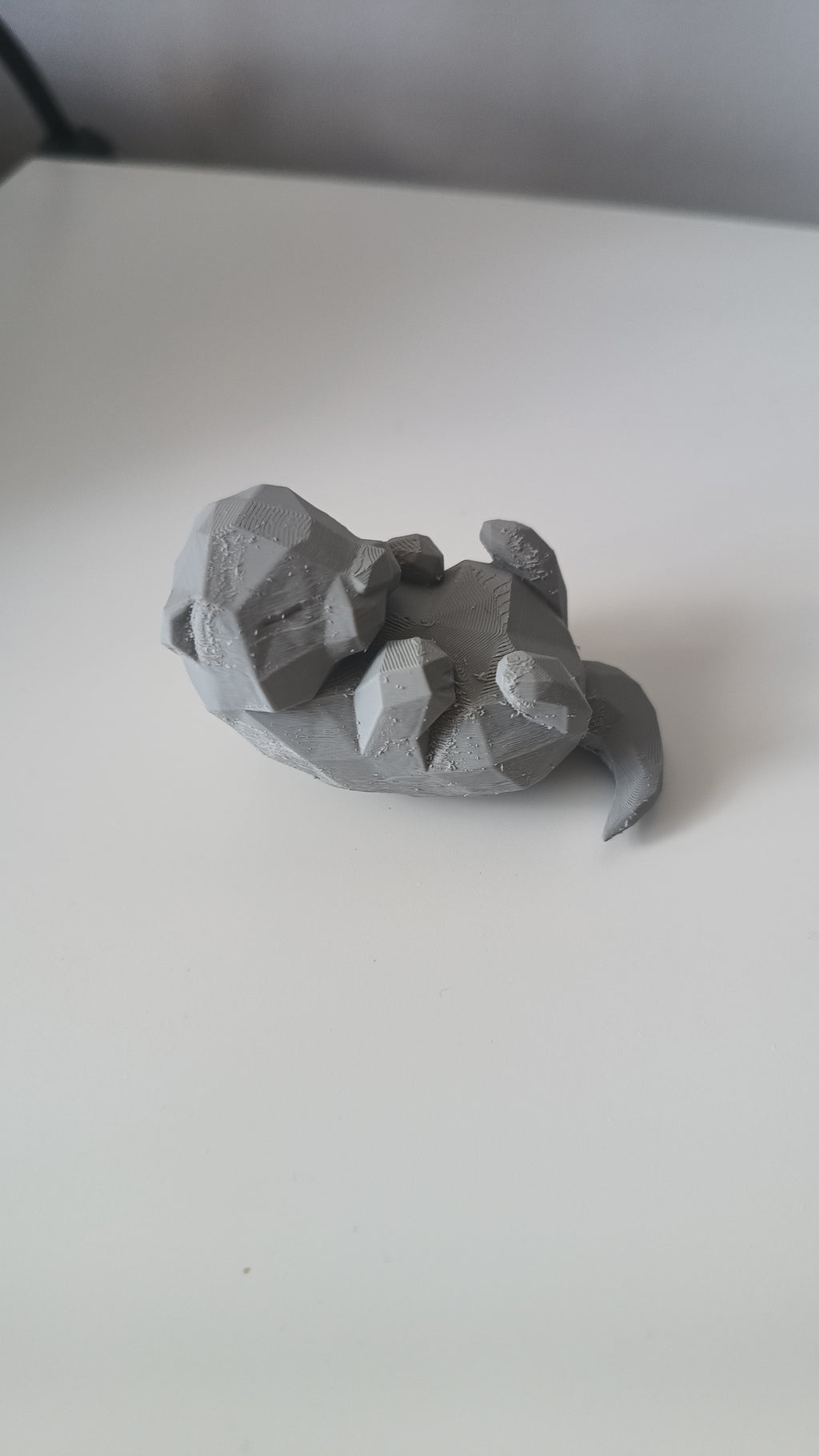 Low Poly Sleeping Otter Figurine