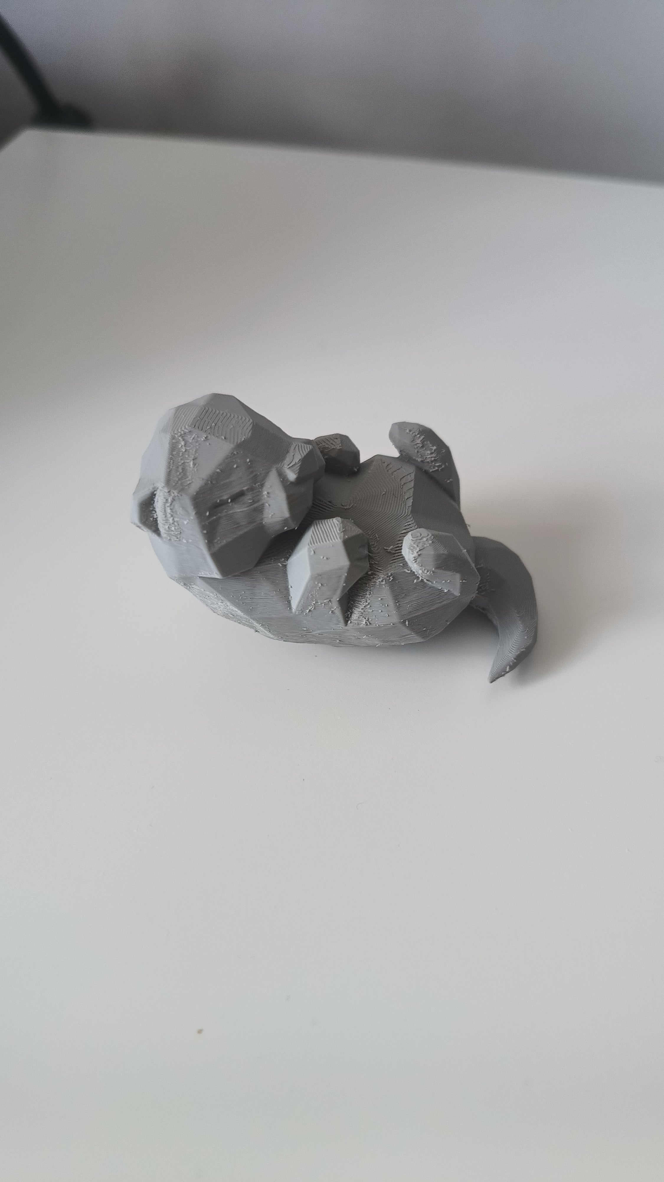 Low Poly Sleeping Otter Figurine