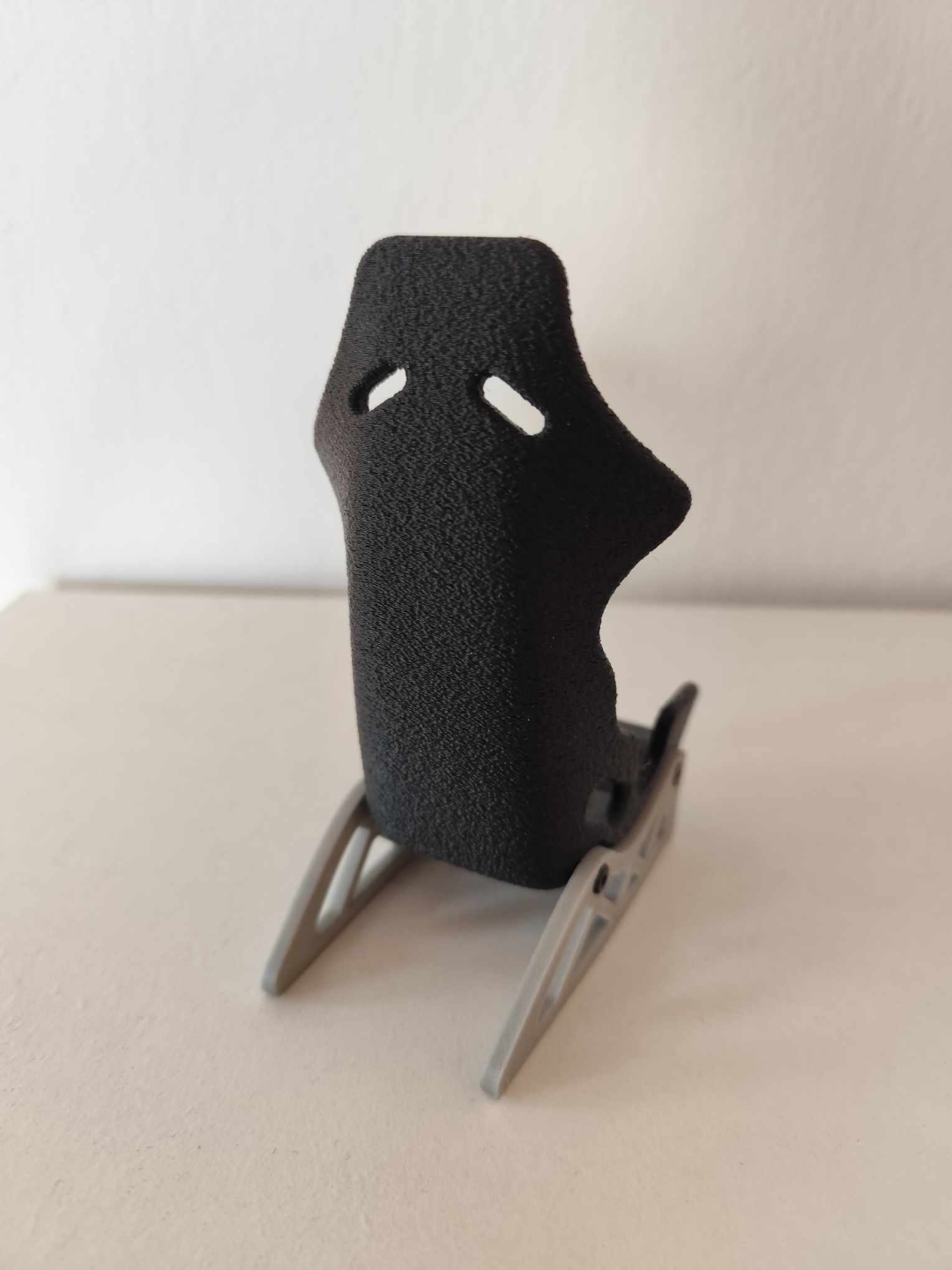 Racing seat phone stand