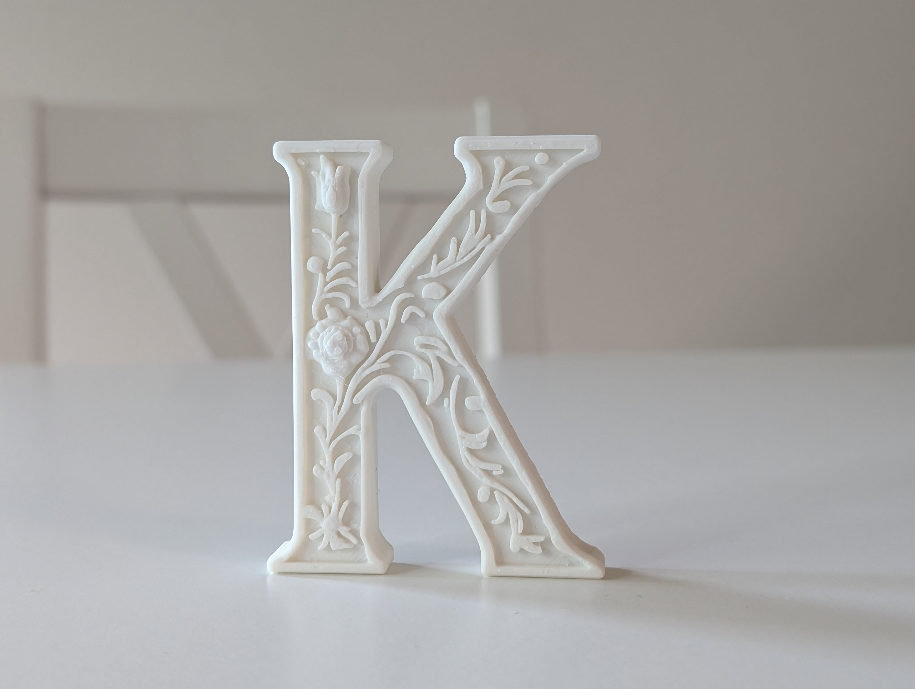 Standing Letter K in a Gypsum Floral Style