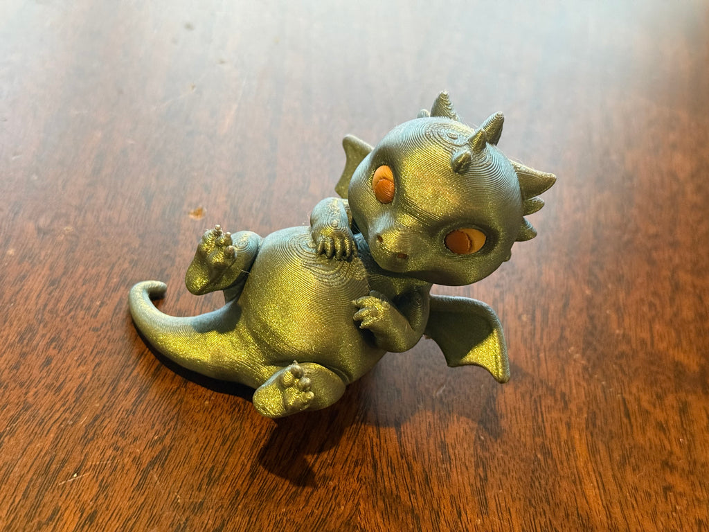 Adorable lounging baby dragon