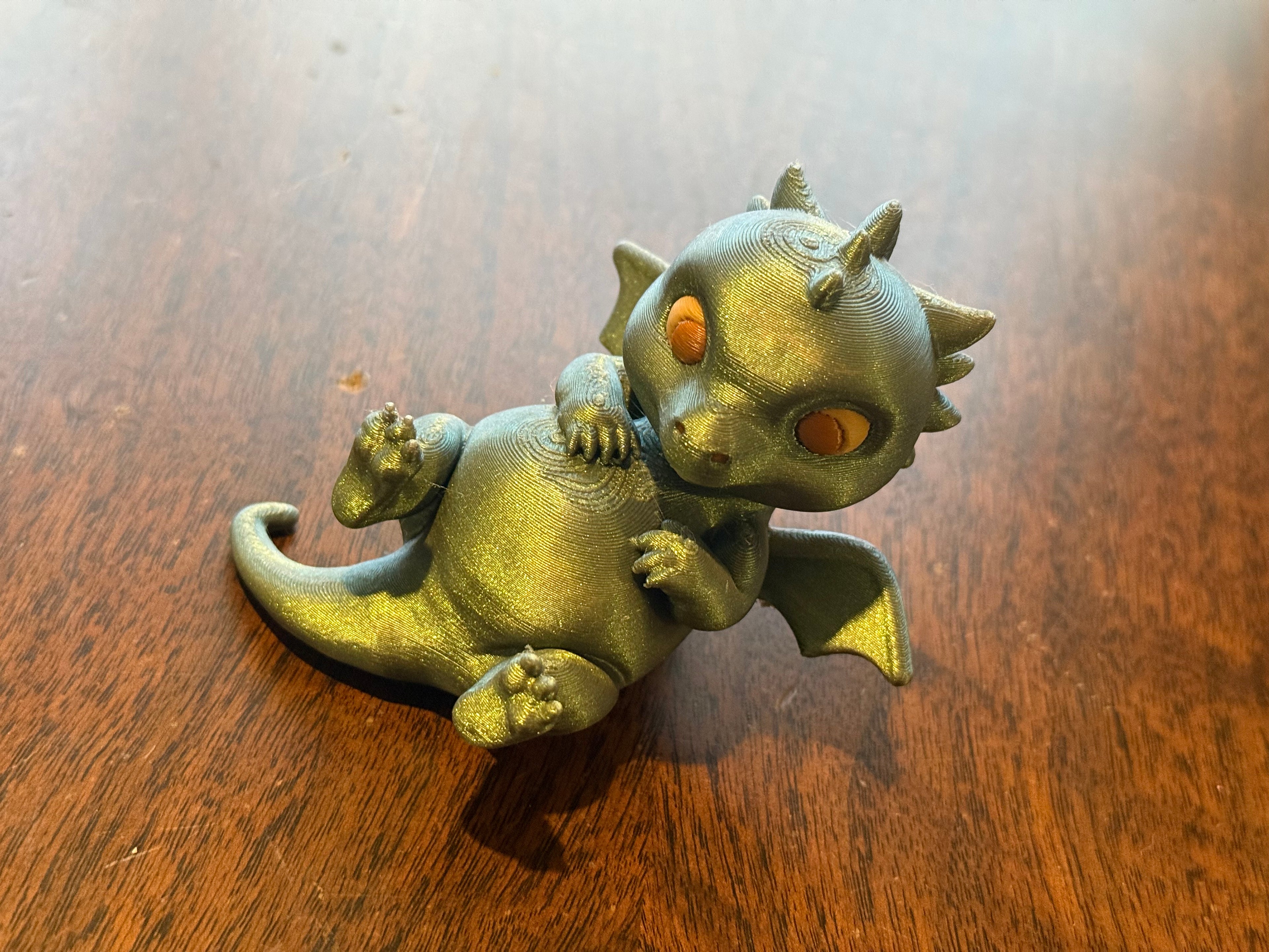 Adorable lounging baby dragon