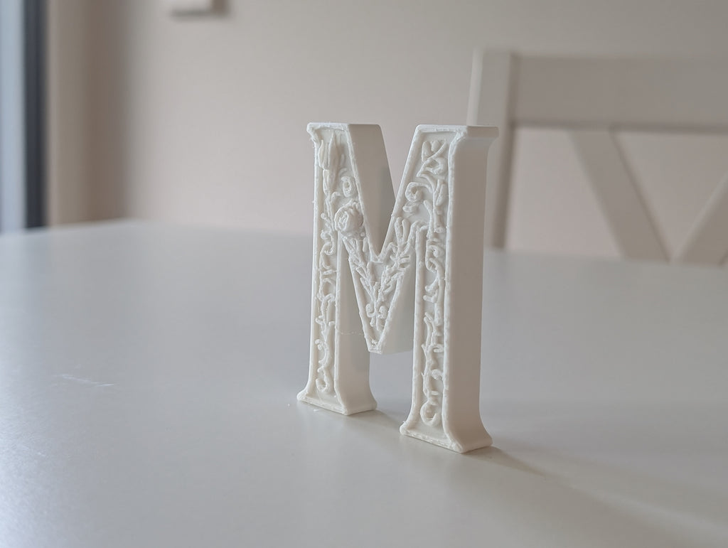 Standing Letter M in a Gypsum Floral Style