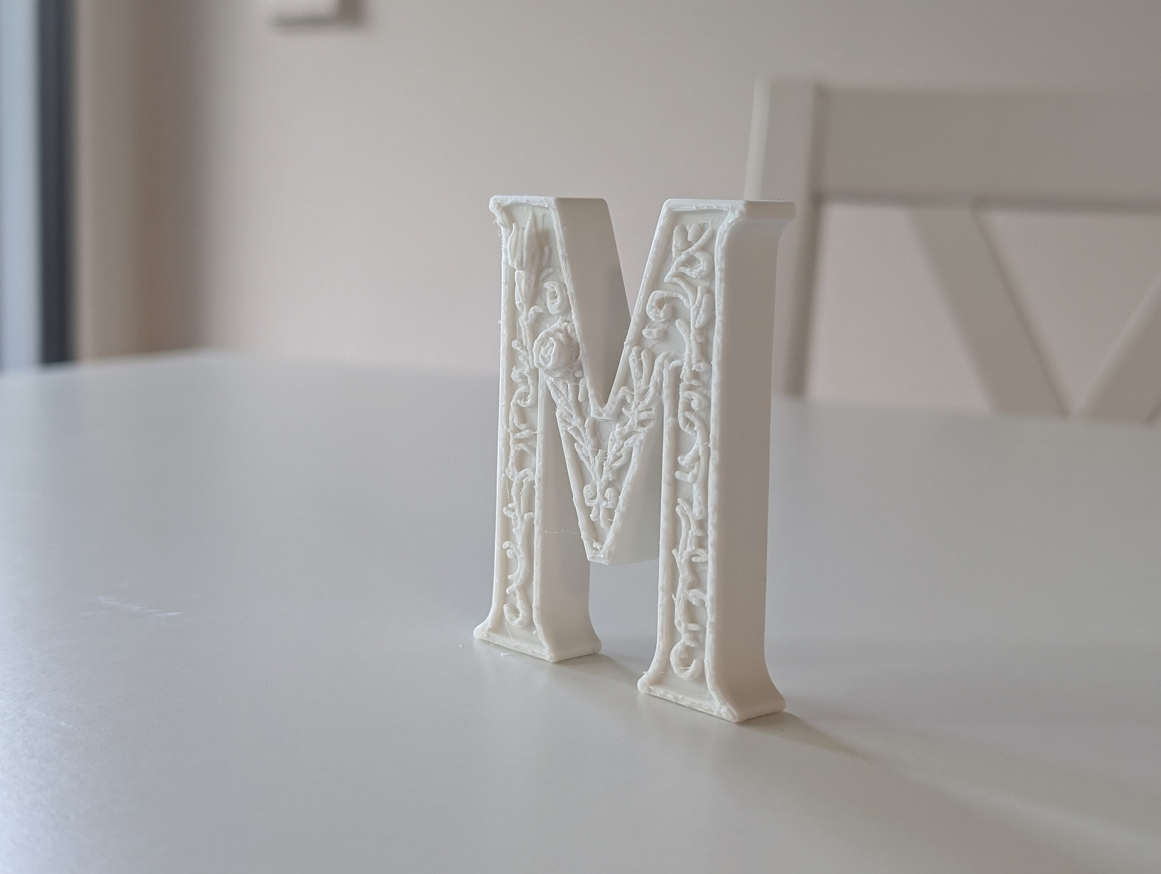 Standing Letter M in a Gypsum Floral Style