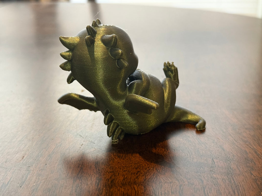 Adorable lounging baby dragon