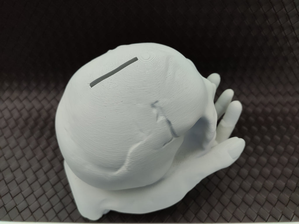 Skull in Hand - Coin bank / Piggy bank