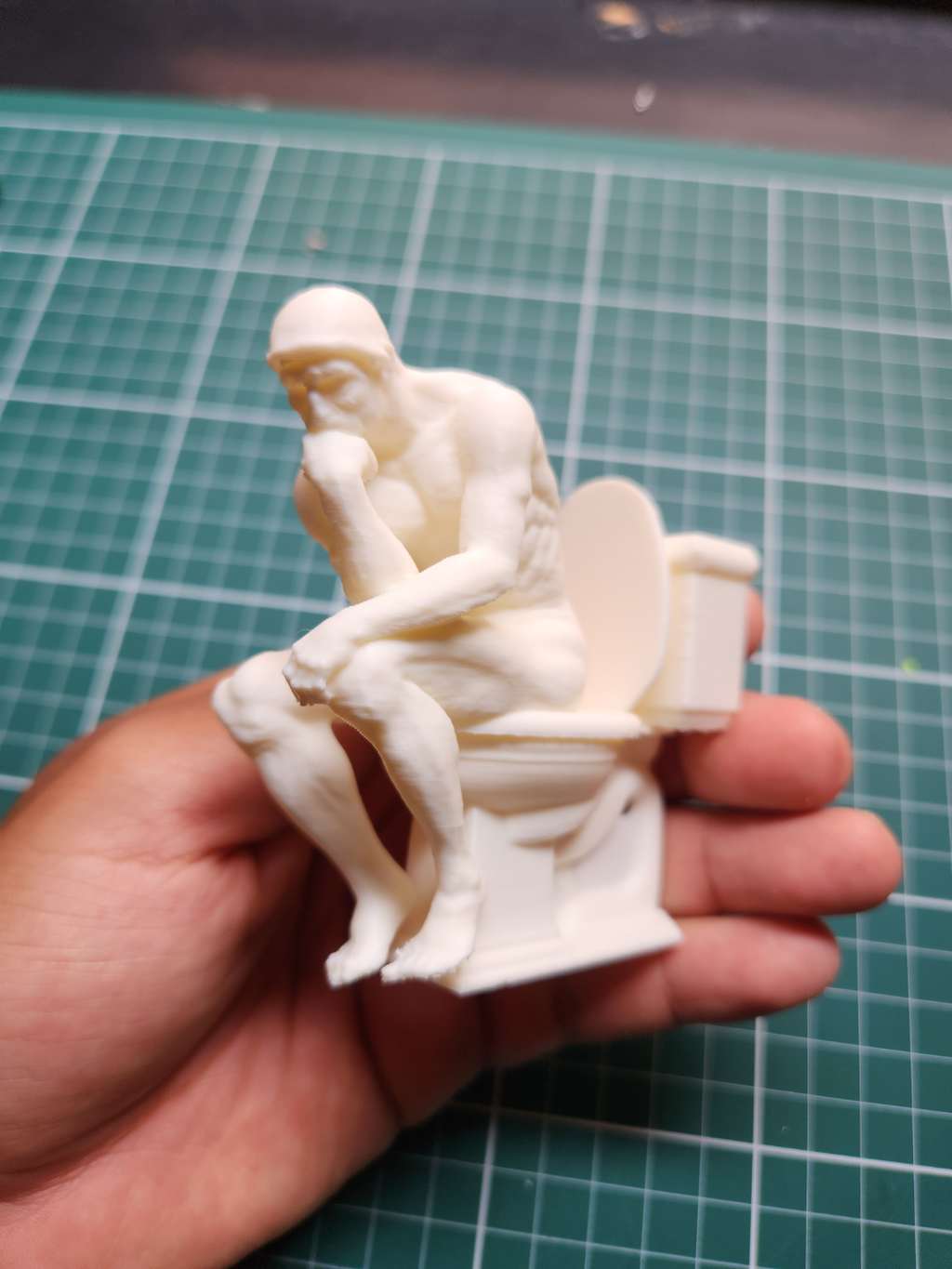 the Thinker on the toilet