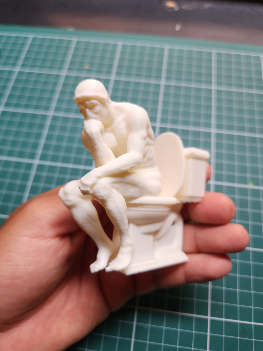 the Thinker on the toilet